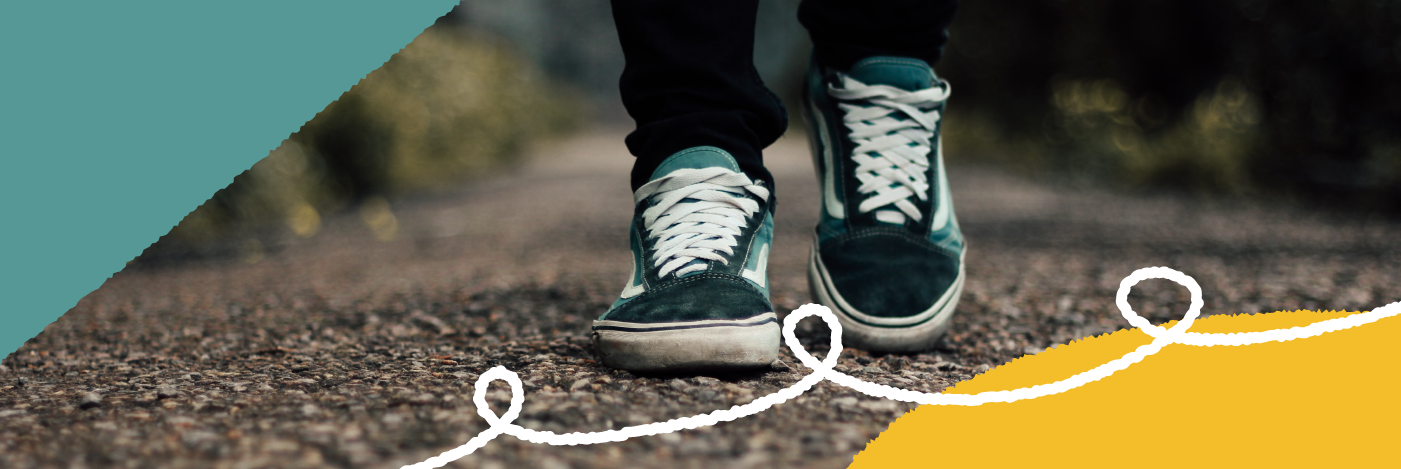 Photograph of someone's shoes as they walk down a path